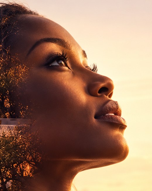 A woman in profile looking up with calm focus